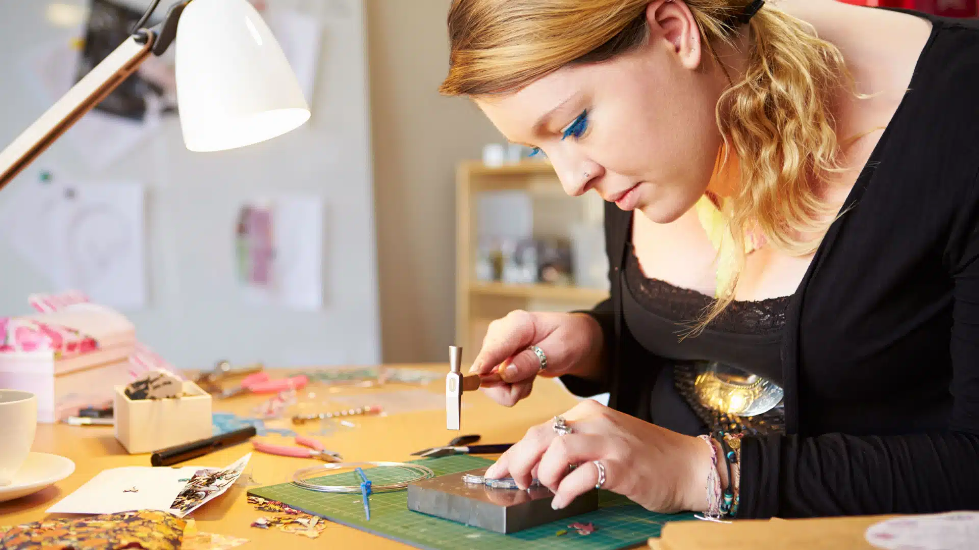 a woman who works at a cheap hobby, like making jewelry at home, to represent cheap hobbies