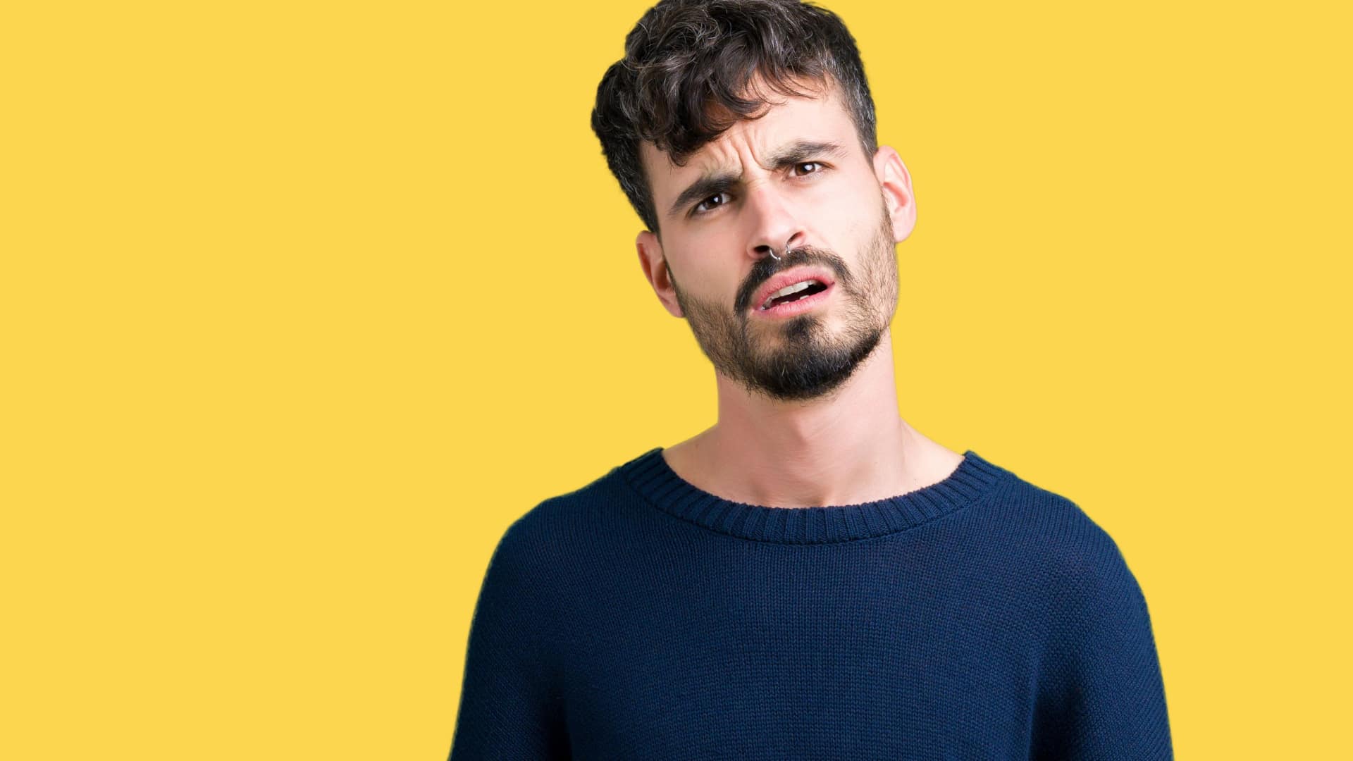 Man tilting his head and making a confused face.