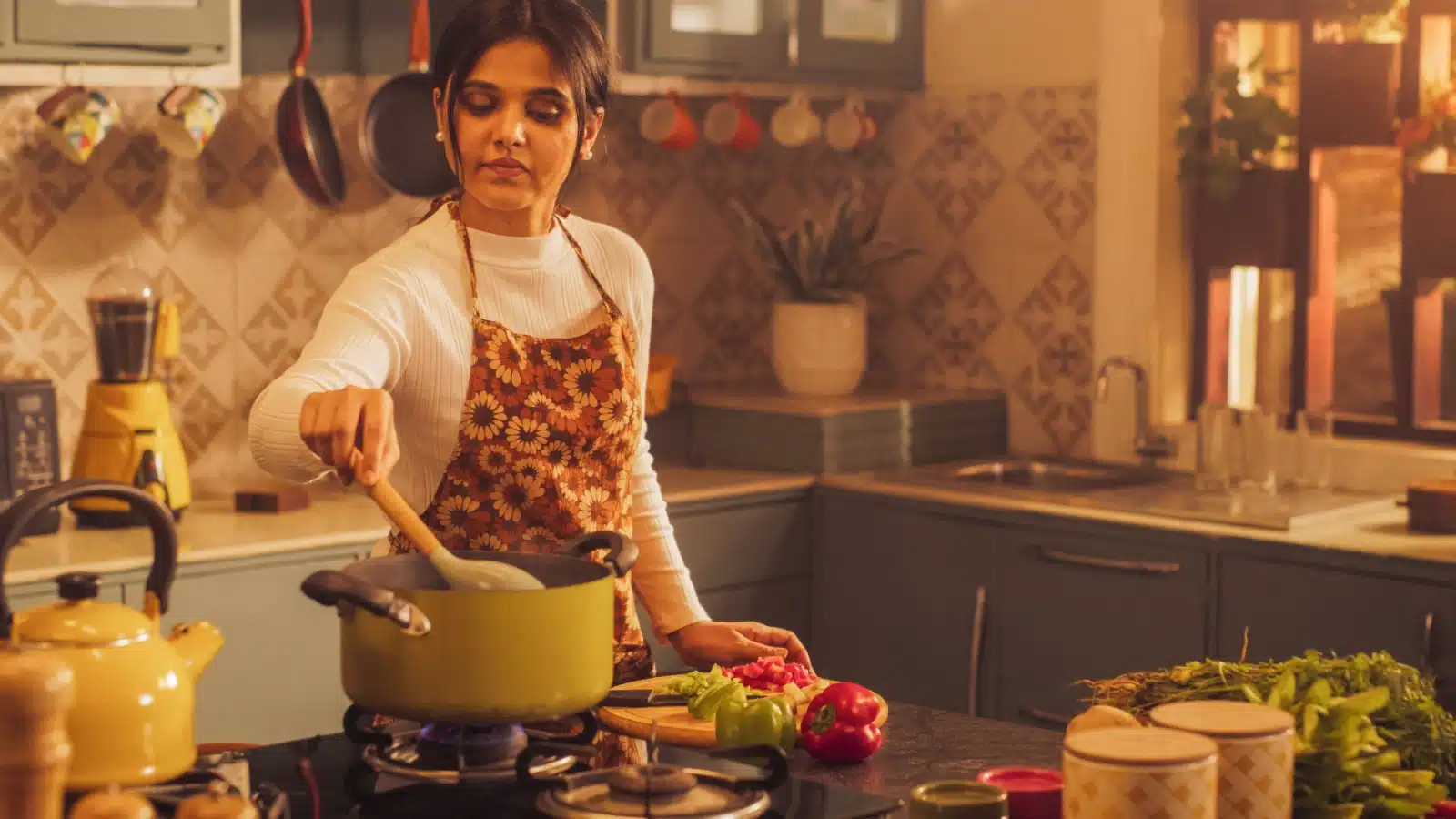 A woman focuses on her stew while cooking.