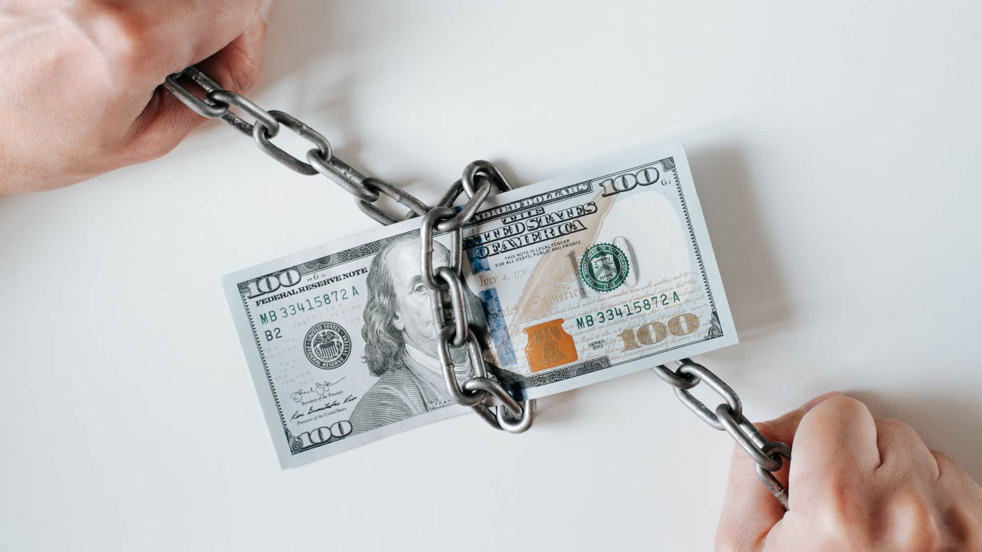 hundred dollar bill locked up in a chain.