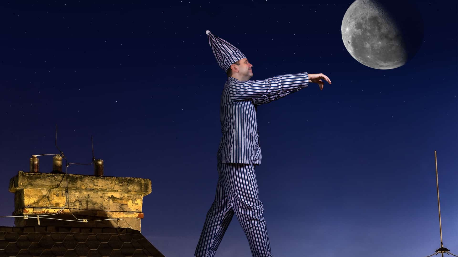 man in pajamas with his arms out sleepwalking under the moonlight.