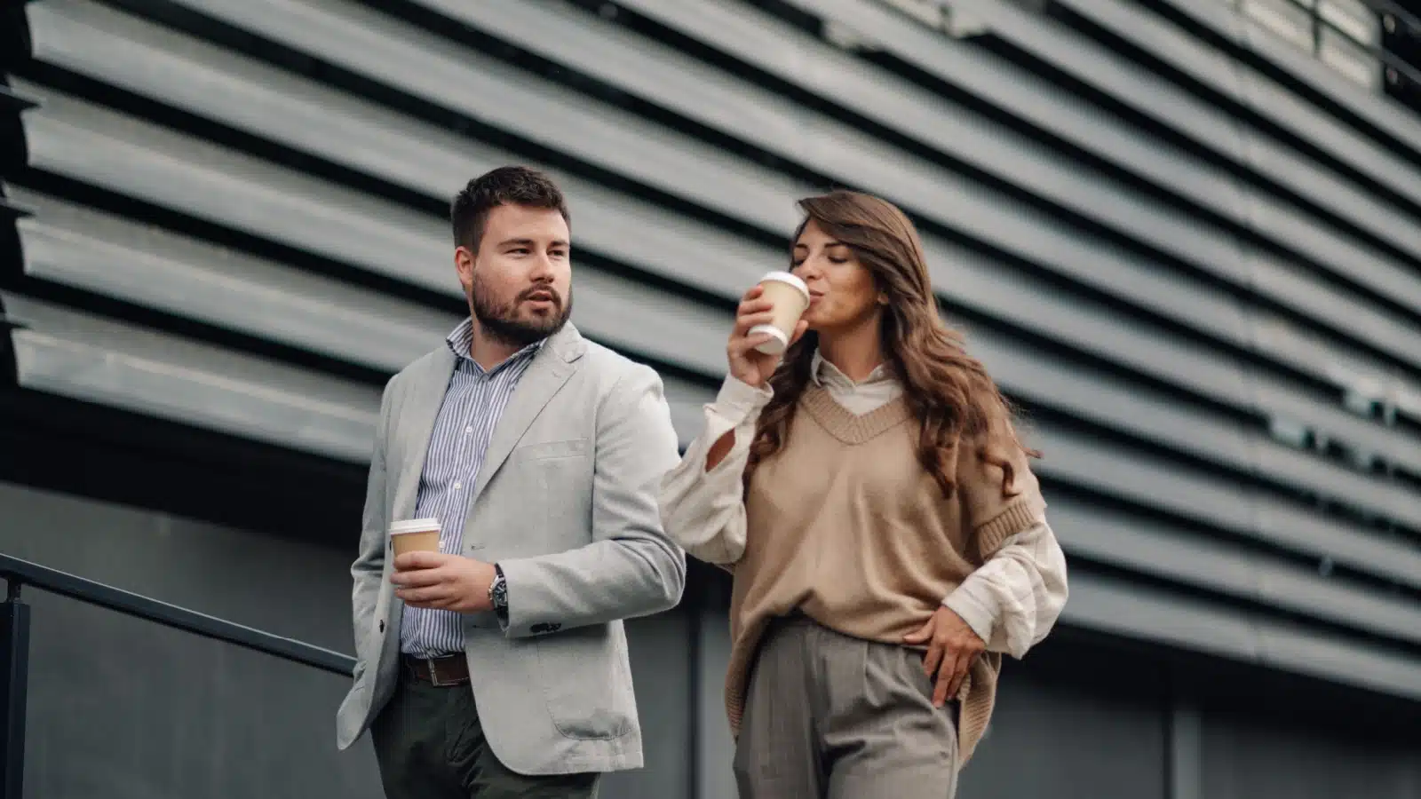 Work colleagues enjoy a walking coffee break.