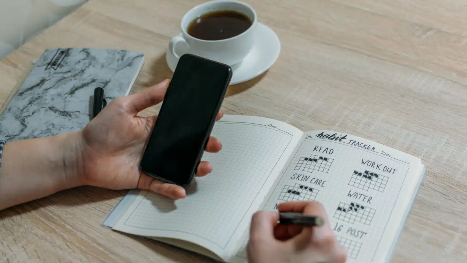 A person tracking habits in their journal.