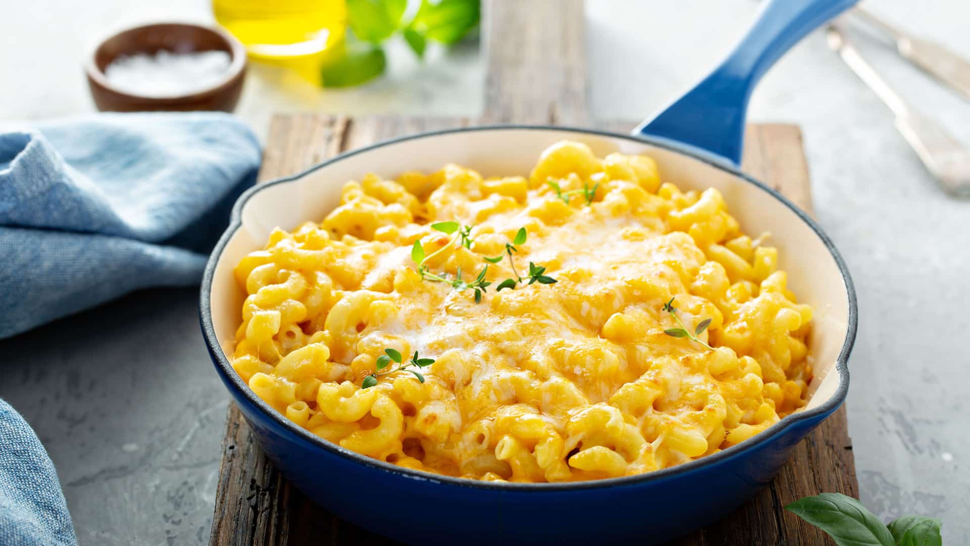 baked mac and cheese in a blue frying pan.