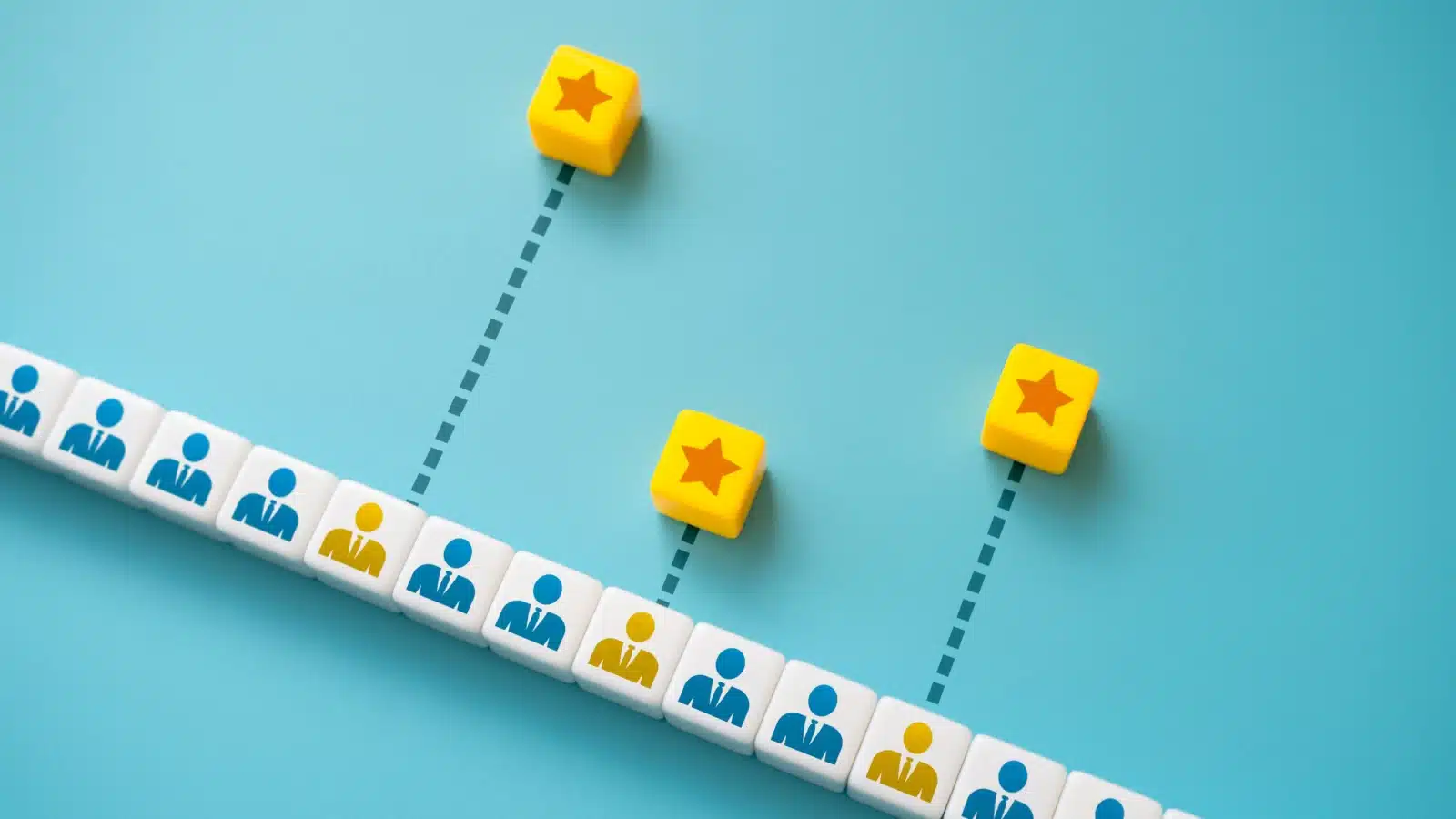 Concept art that represents rewarding merit. A line of tiles represents employees. Three gold colored employees have stars rising above them.