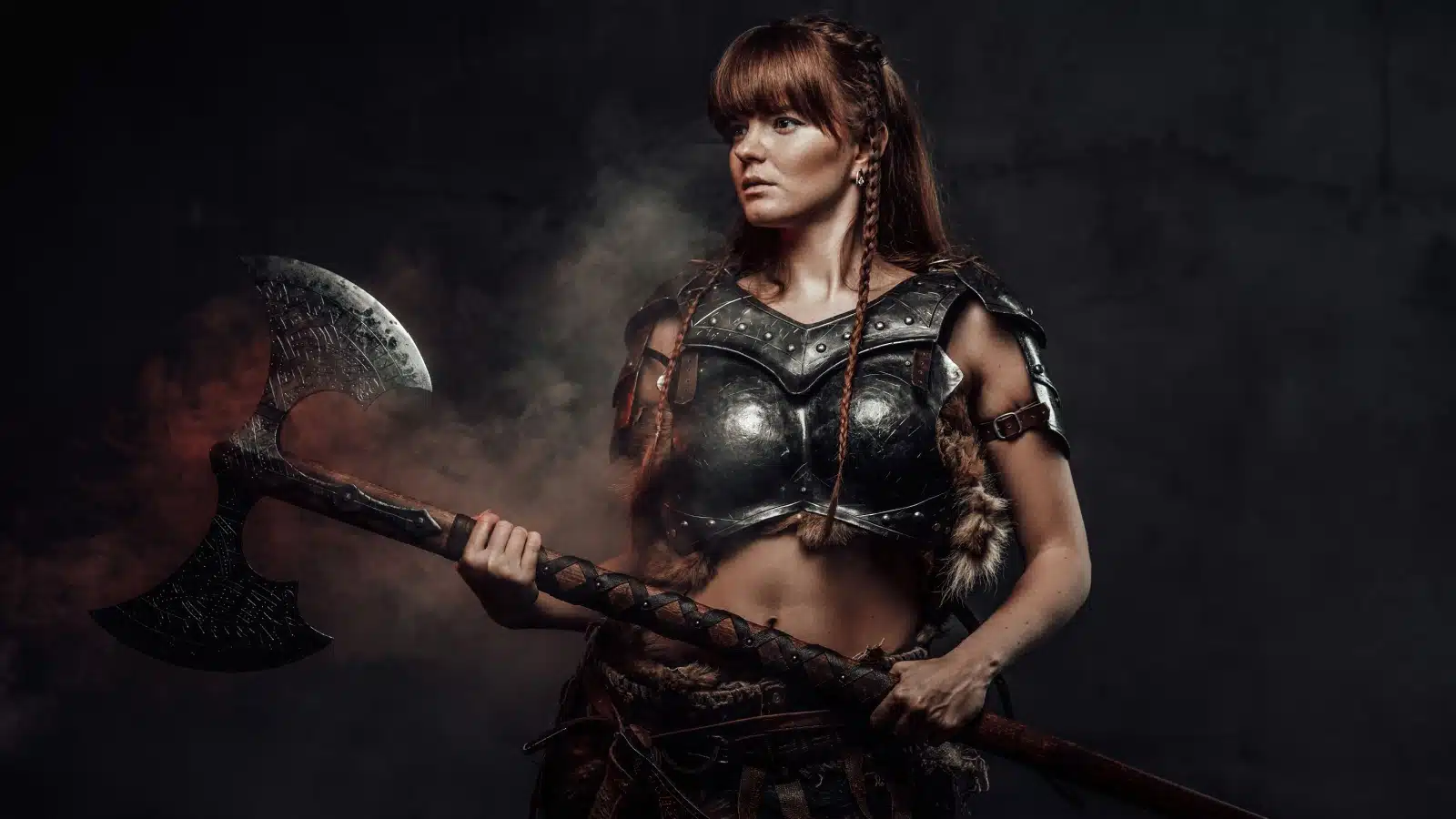 A Norse warrior woman posing with a battle axe.