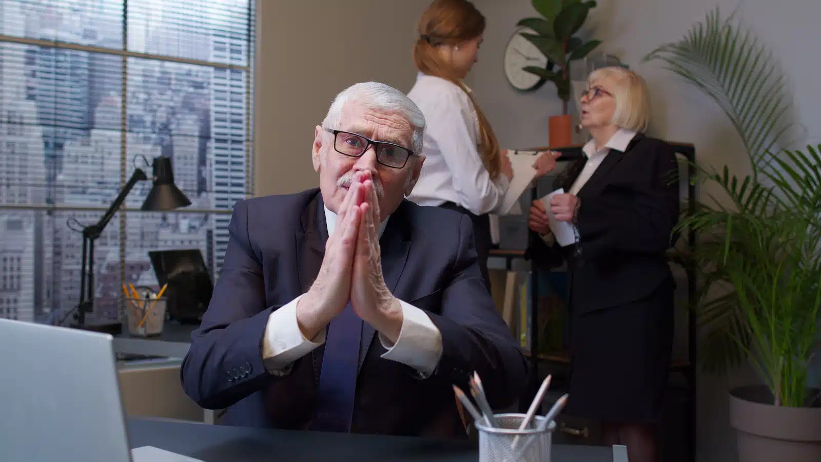 Boss pleads with employees in a begging posture. 