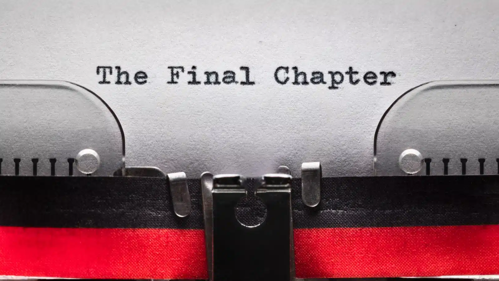 A typewriter with a paper saying "The Final Chapter" coming out to represent the falling action of a story.