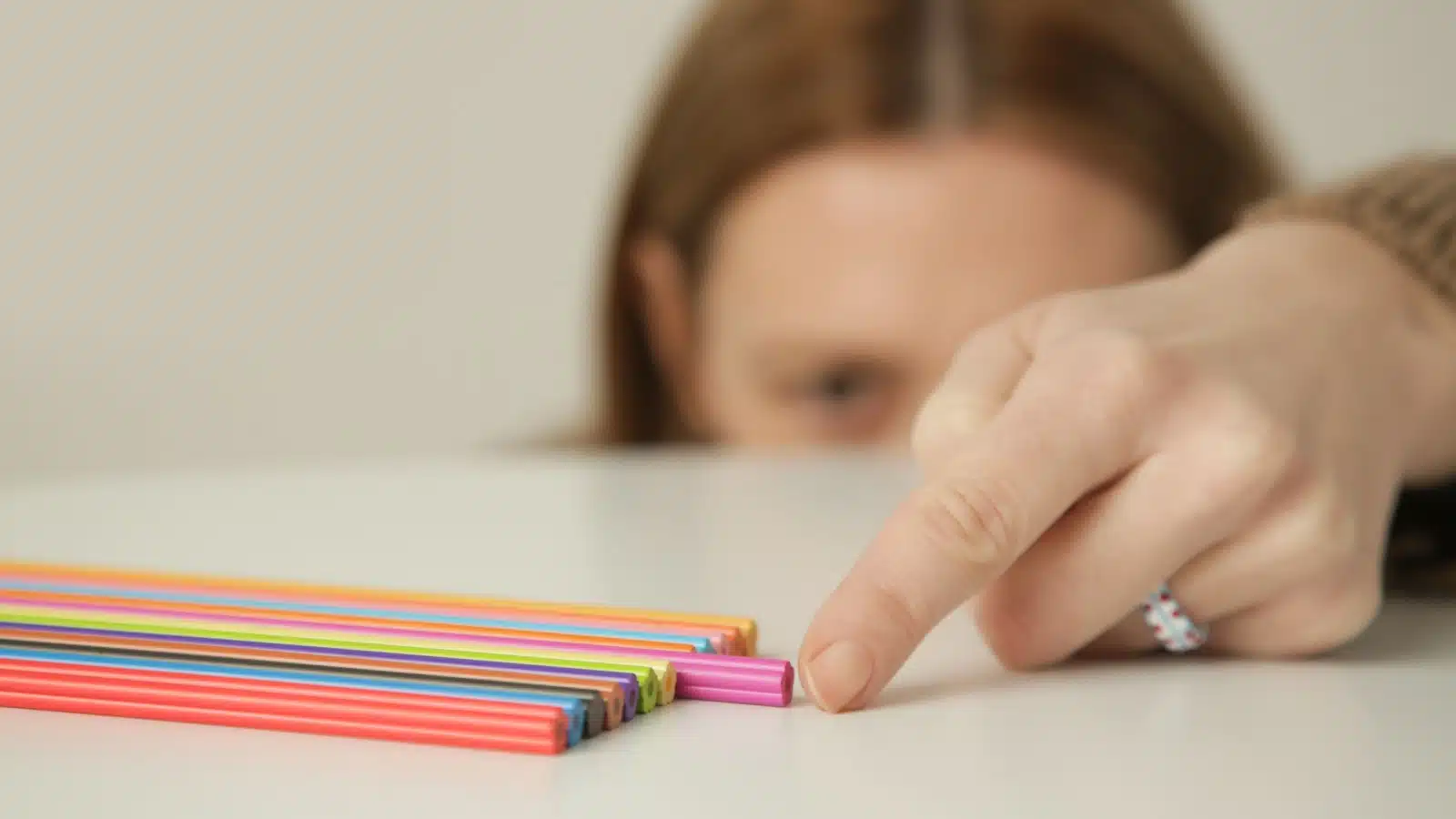 A perfectionist making sure pencils are perfectly aligned.
