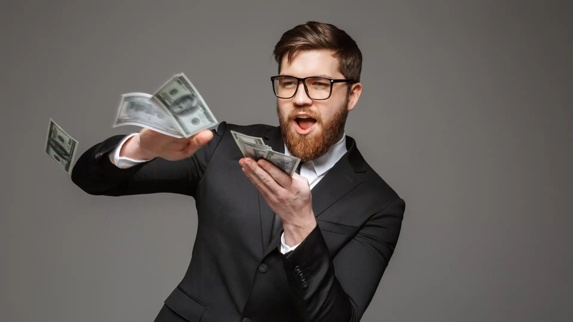 A man making rain with a pile of money in his hand.