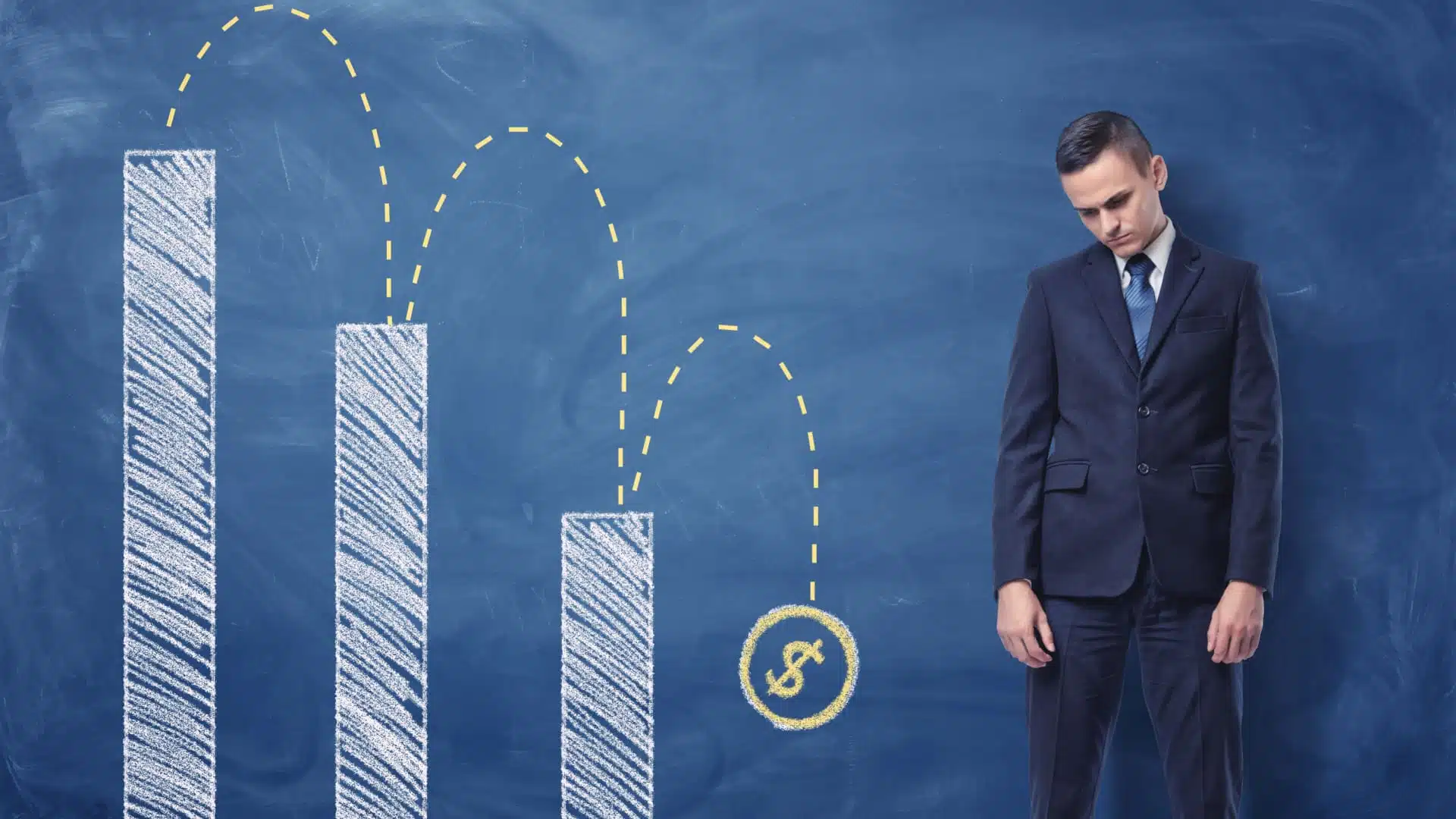 A business man stands next to a graph showing massive losses. 