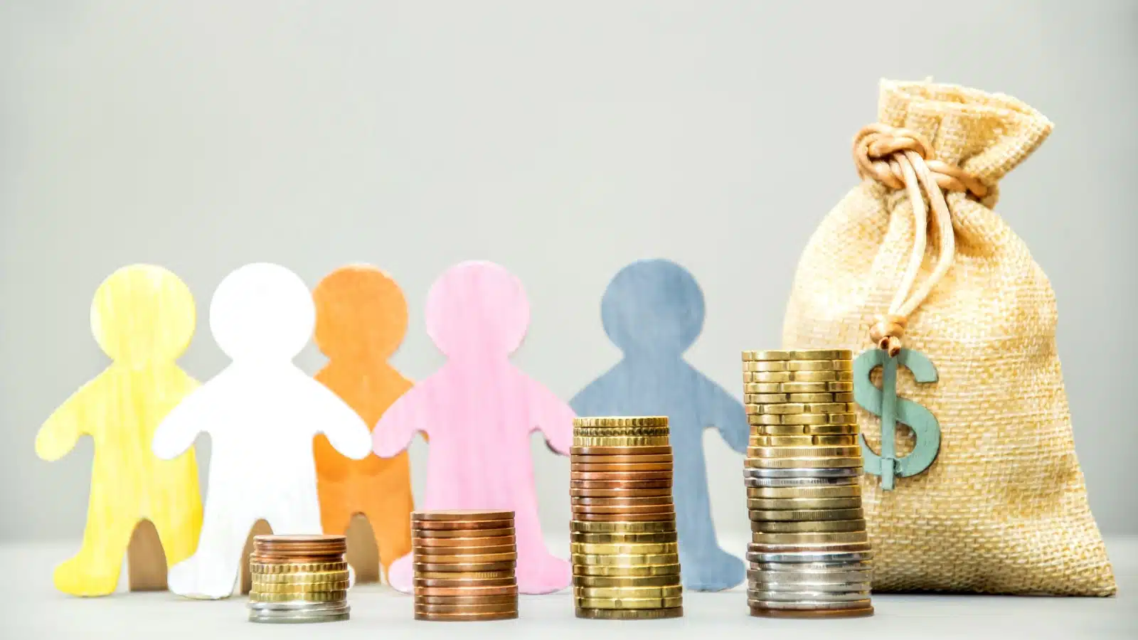 Different colored cutouts of people behind stacks of change to represent how people have varying financial needs.