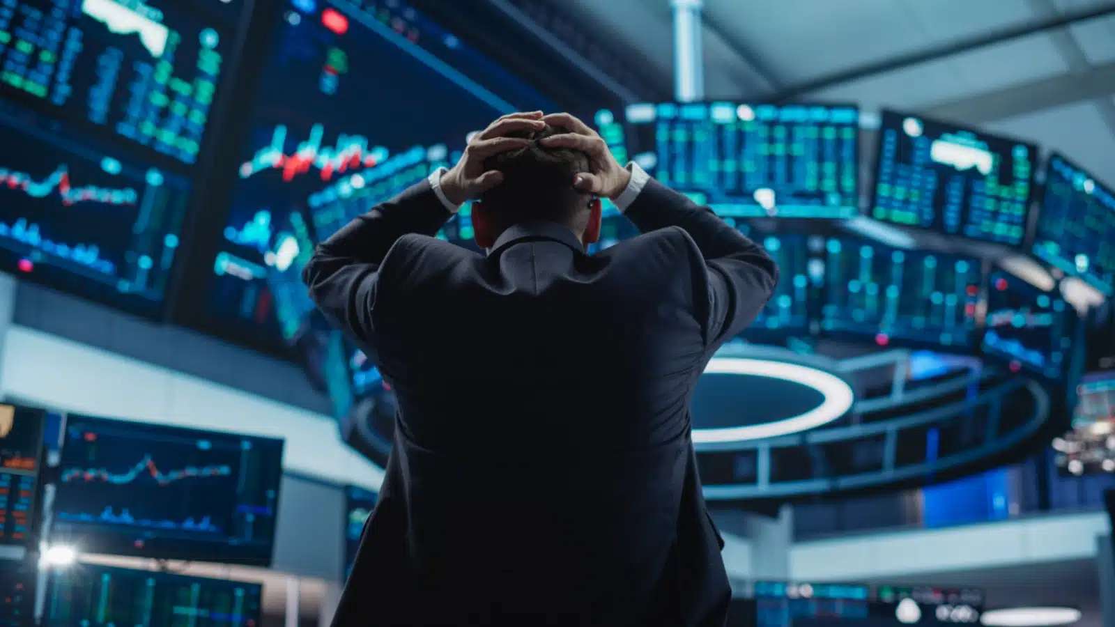 A broker on the floor of the Stock Exchange with his hands on his head due to economic turmoil. The image represents how to prepare for a market crash.