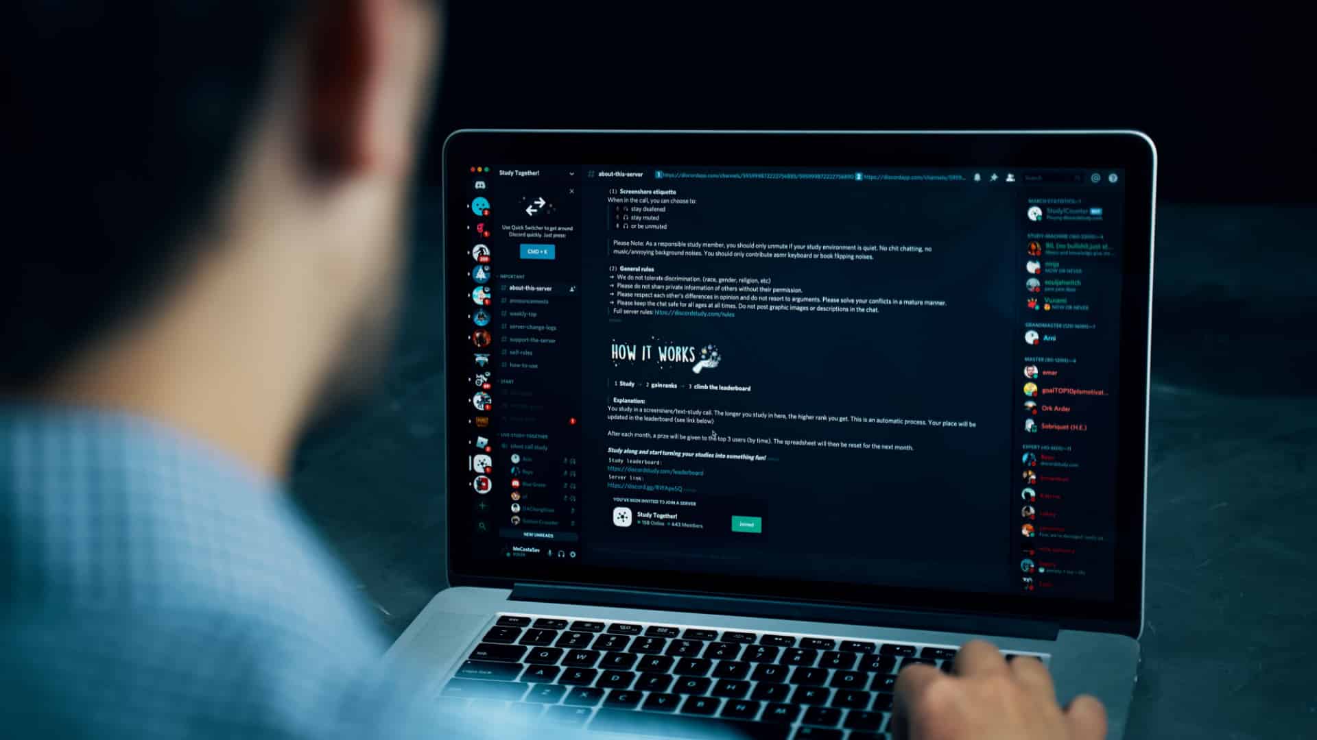 A man using Discord on his laptop.