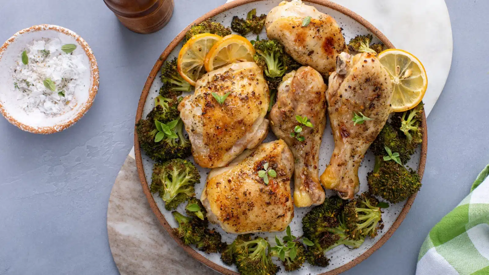 A dinner plate with chicken and roasted broccoli.