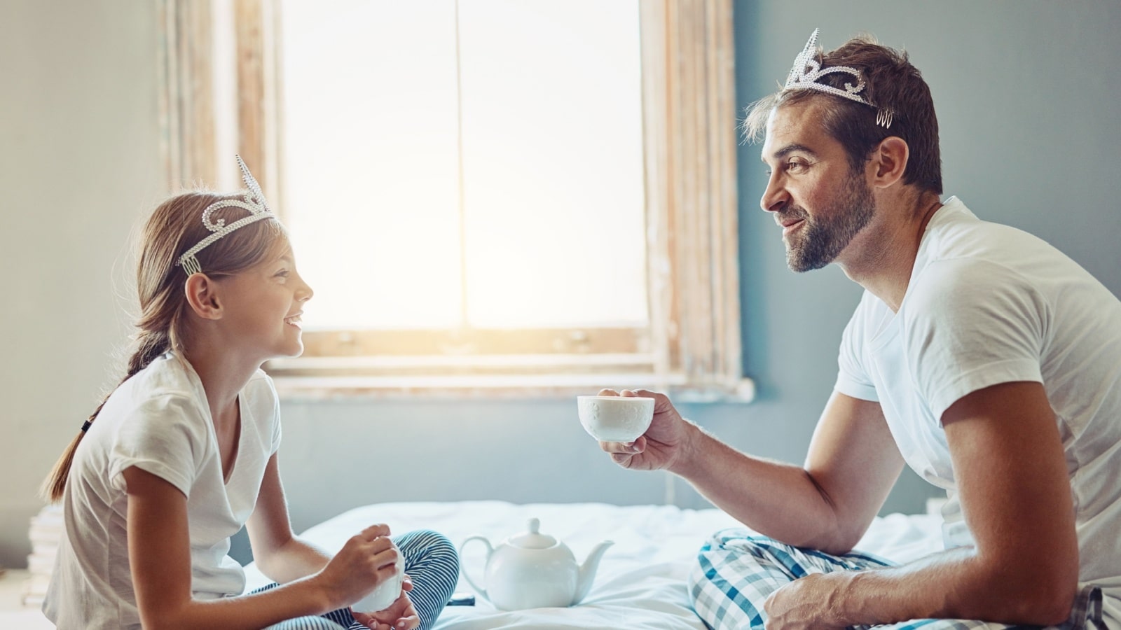 A dad having a tea party with his daughter to represent feminine things men should start doing.