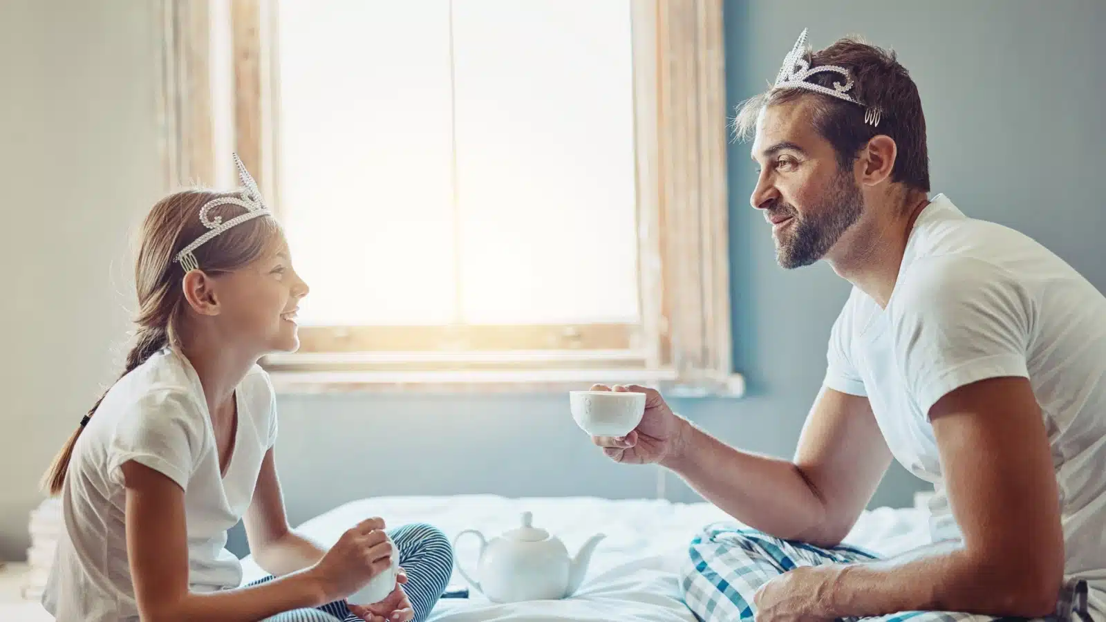 A dad having a tea party with his daughter to represent feminine things men should start doing.