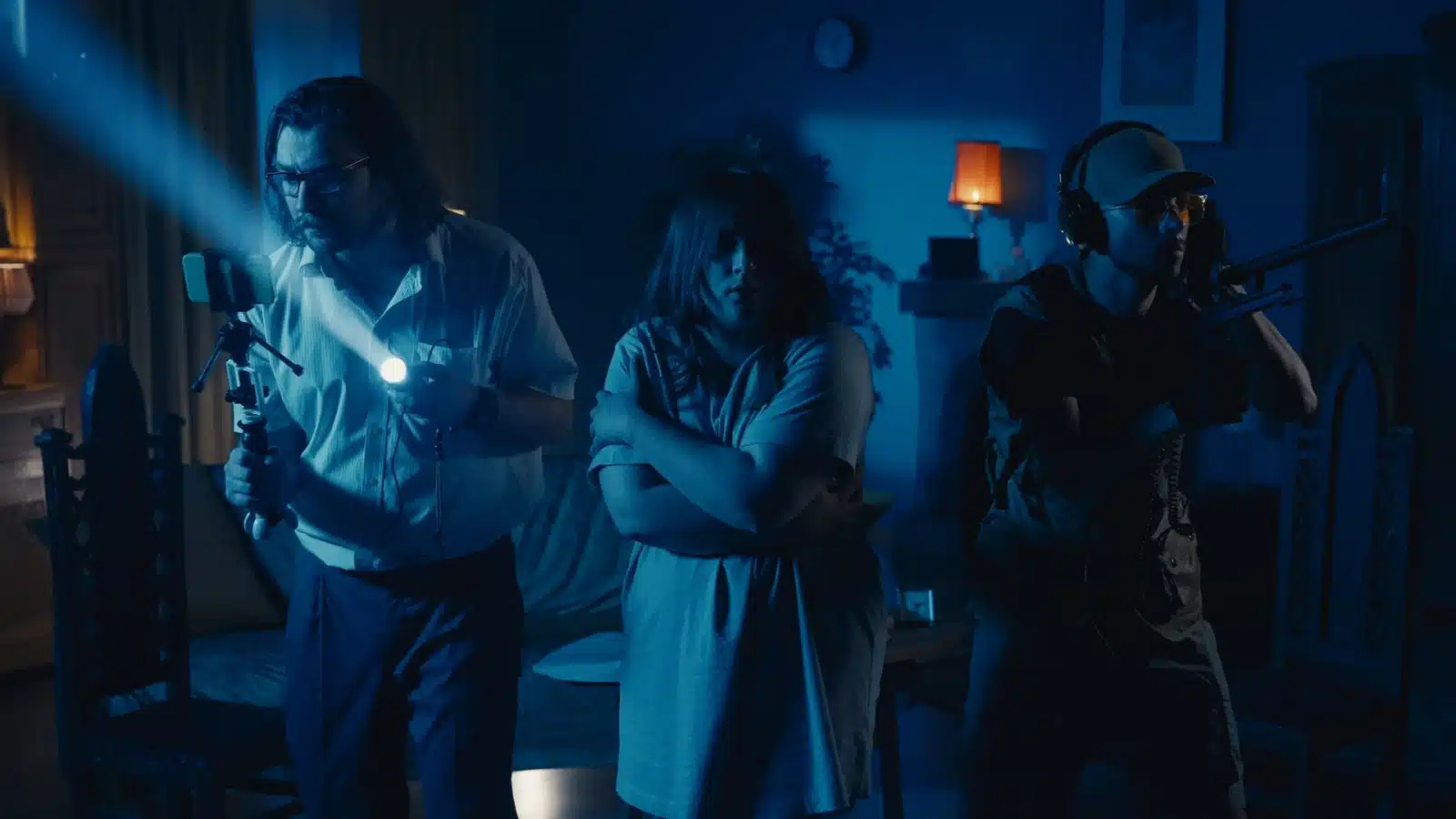 Ghost hunters in a darkened room.