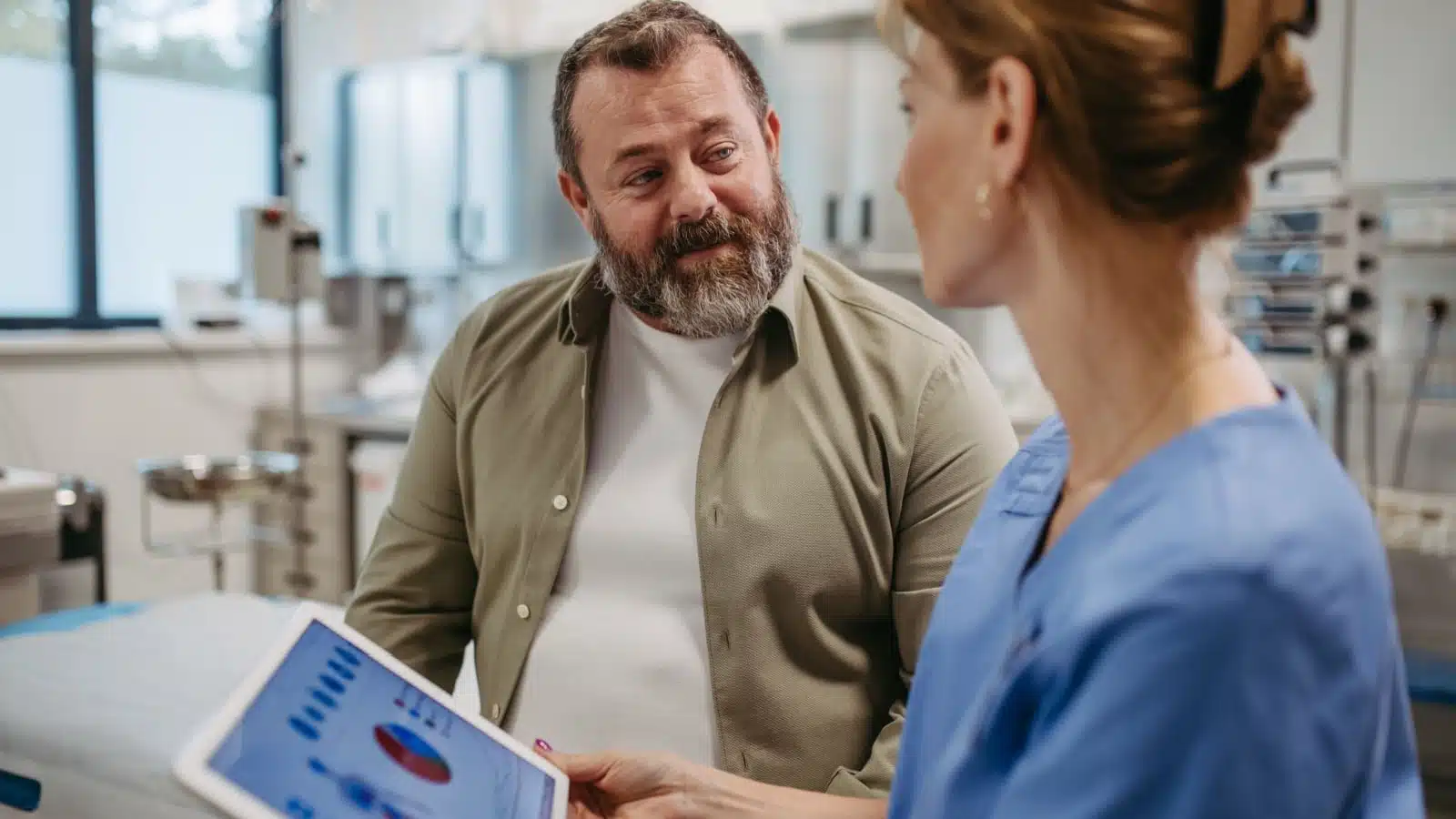 A man at a doctor's office speaking to the doctor. 