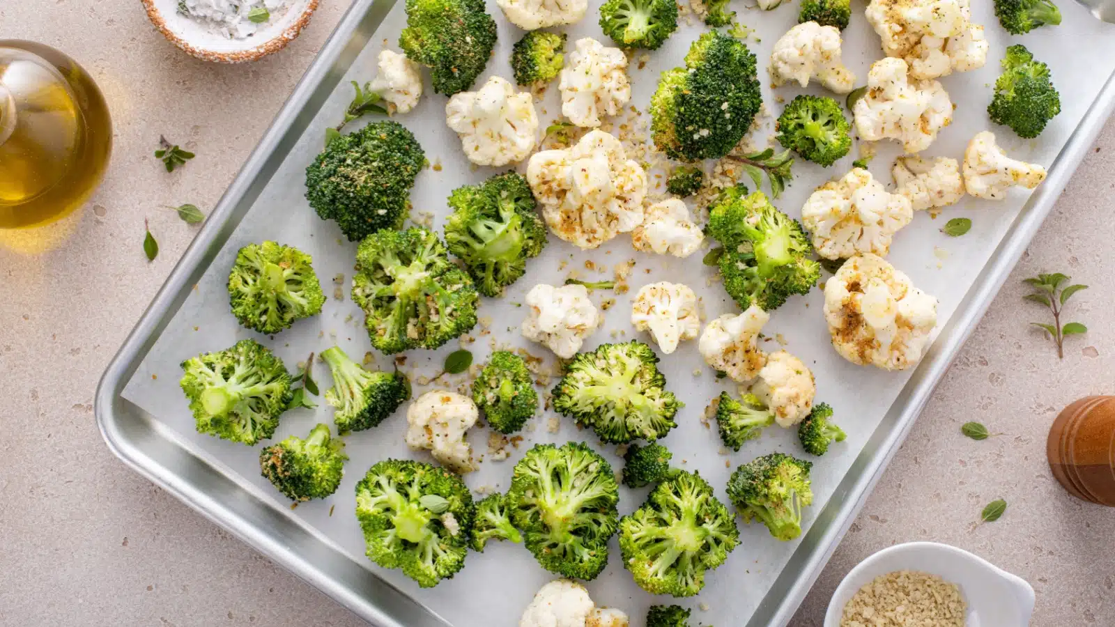 Broccoli and cauliflower spread on a roasting pan.