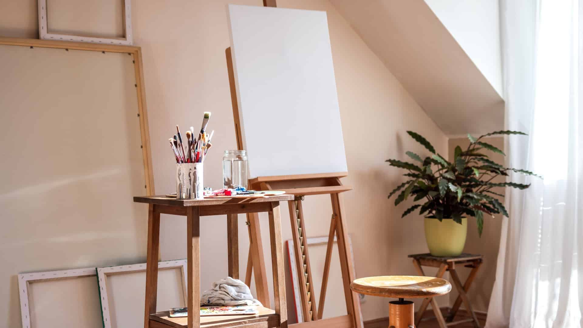 A blank canvas on an easel in an artist's studio.