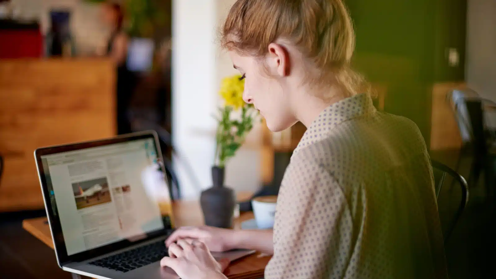 A woman uses her laptop to work on her blog.