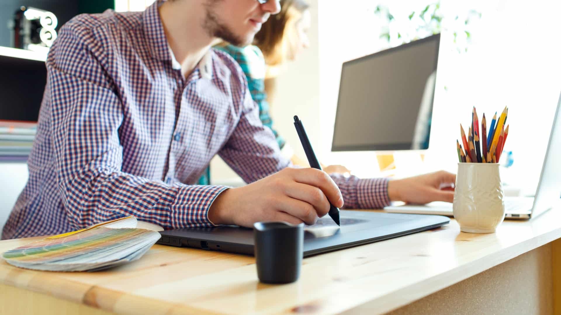 Artist using a pen tablet to create a digital work of art.