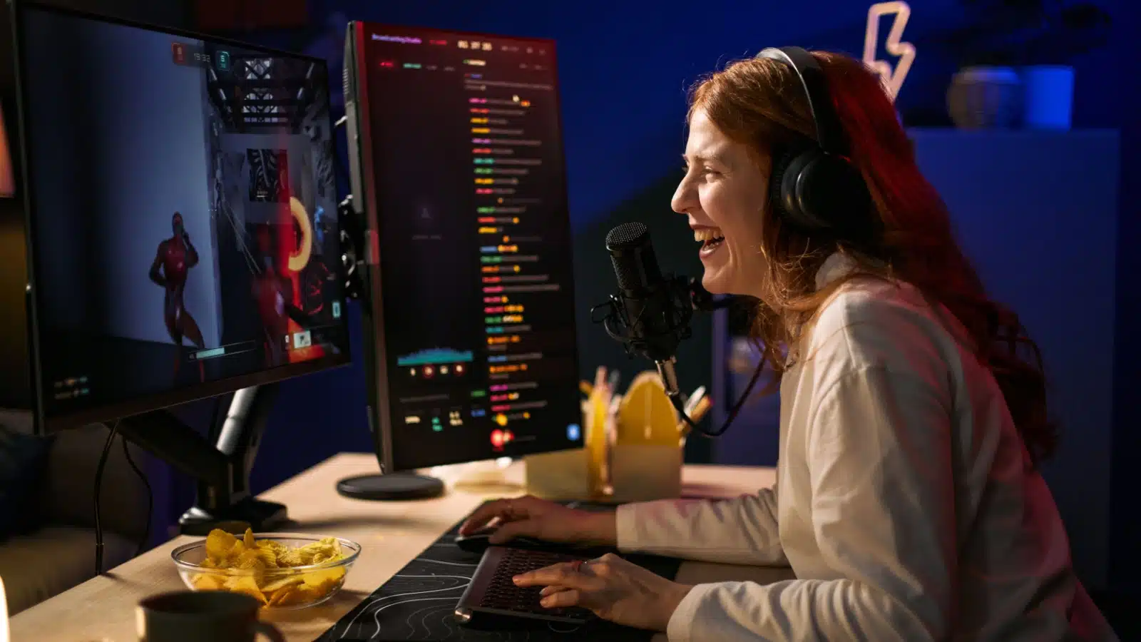 A happy streamer engages with her chat while playing video games.