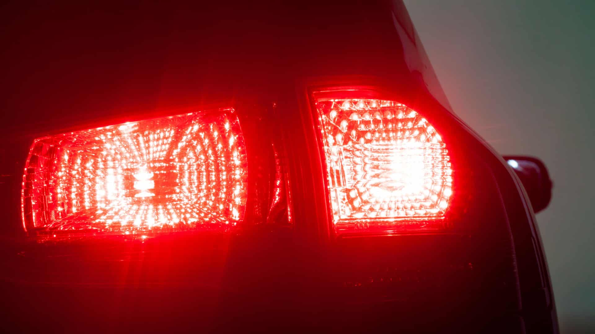 The bright red of a car's brake lights at night.