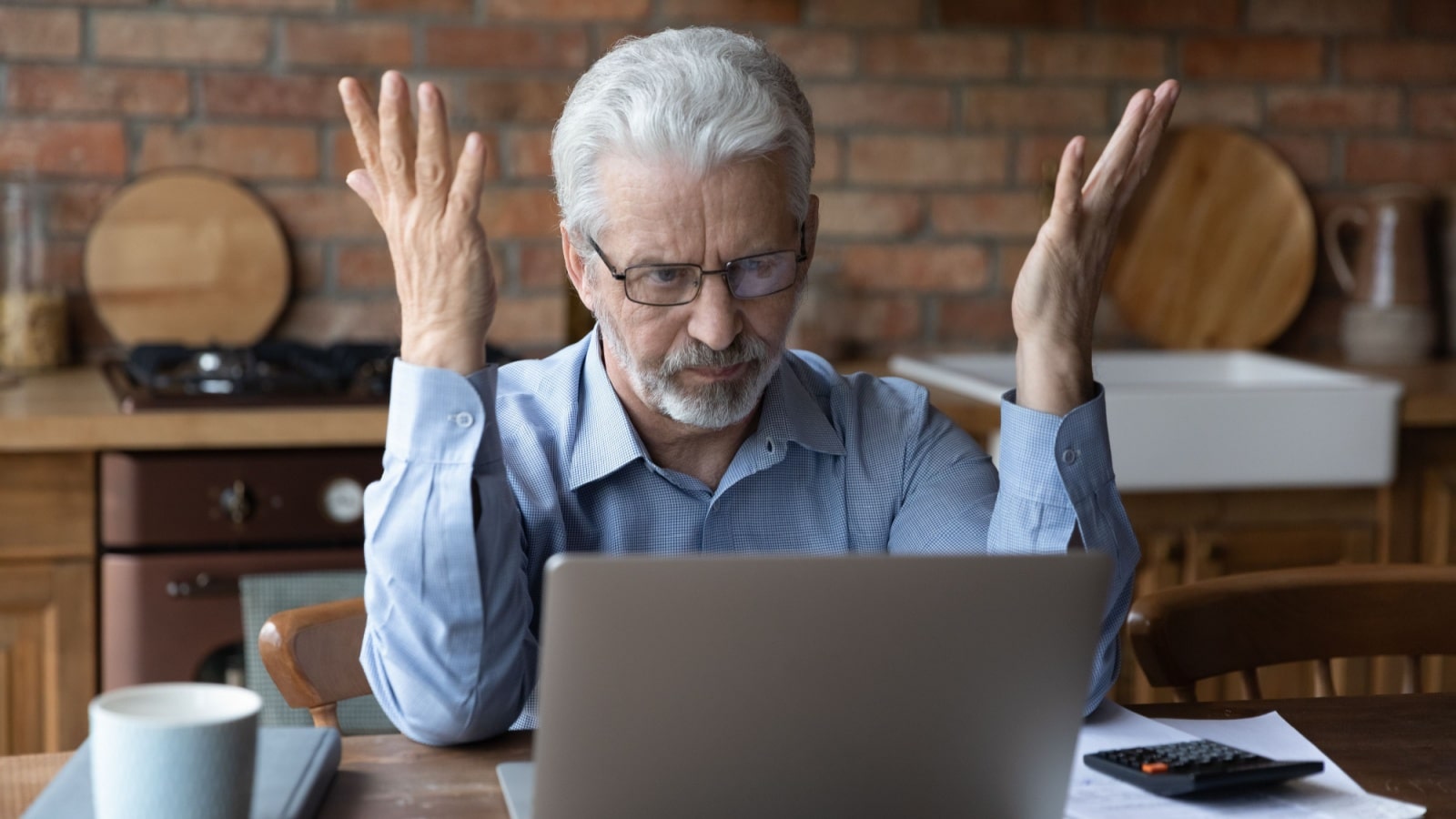 Older frustrated man in front of a computer to represent things we hate as we age.