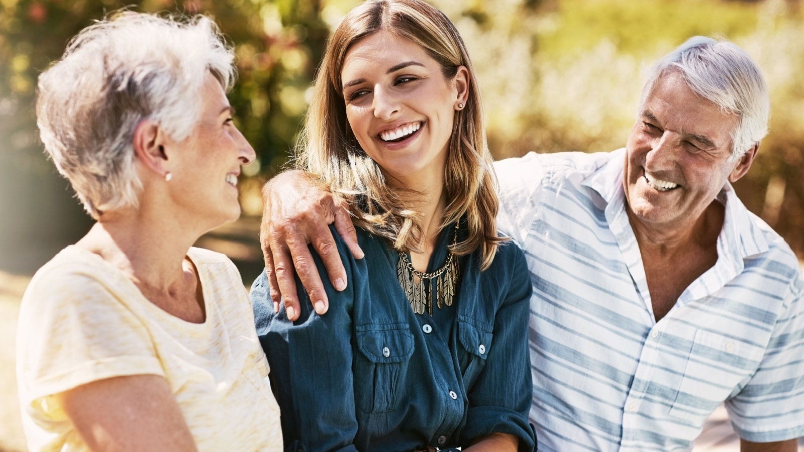 Senior parents on an outing with their adult daughter.
