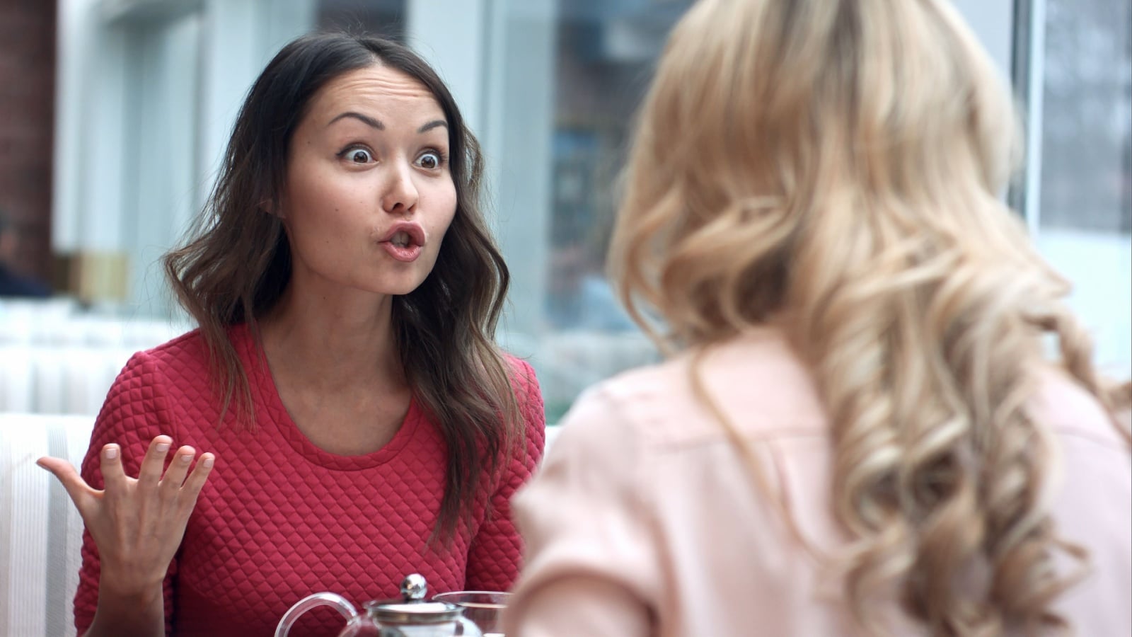 Two women arguing in a cafe.