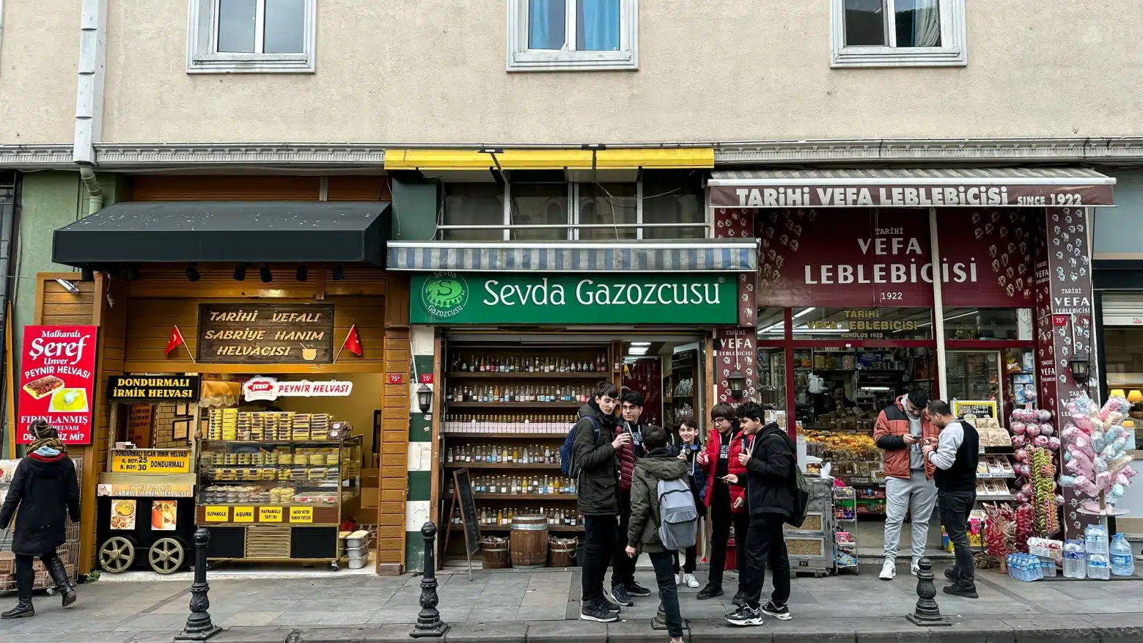 Store owners and tourists standing outside shops in Istanbul.