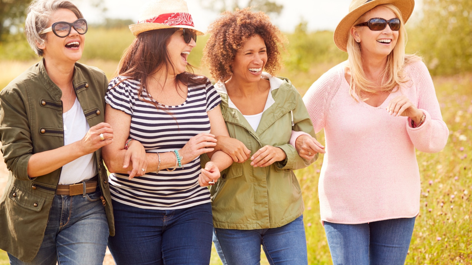 A group of middle aged adult friends enjoying a walk outside.
