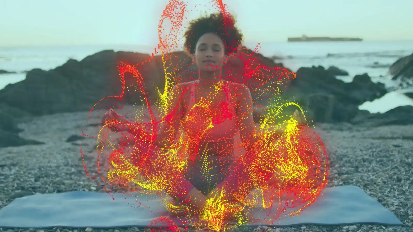A woman meditating on the beach is surrounded by spiritual energy, or good juju. 
