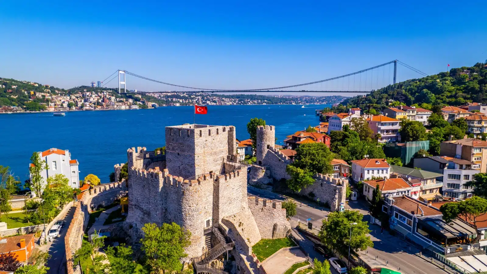 Anadolu-Hisari fortress in Istanbul with the Faith Sultan Mehmet Bridge in the background.
