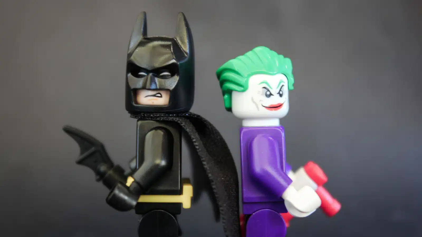 Batman and Joker Lego toys standing back to back.