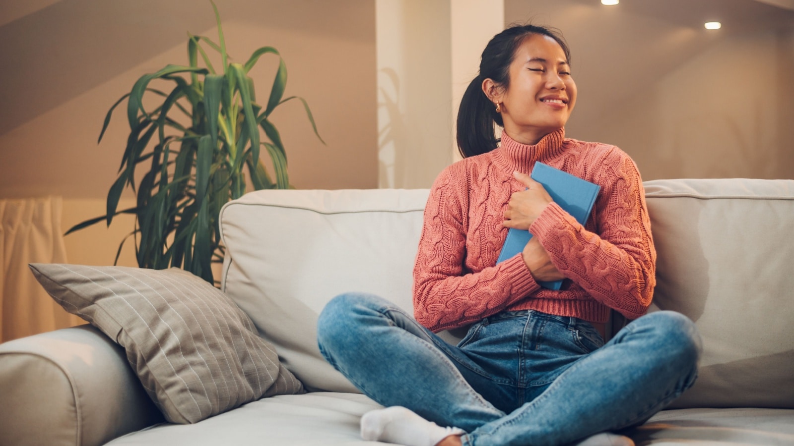A woman hugs her journal to represent the best journals.