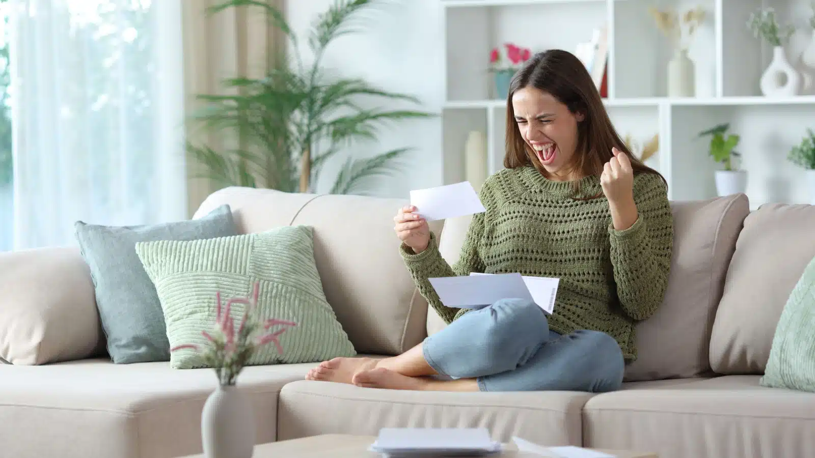 A happy woman celebrates a big unexpected check.
