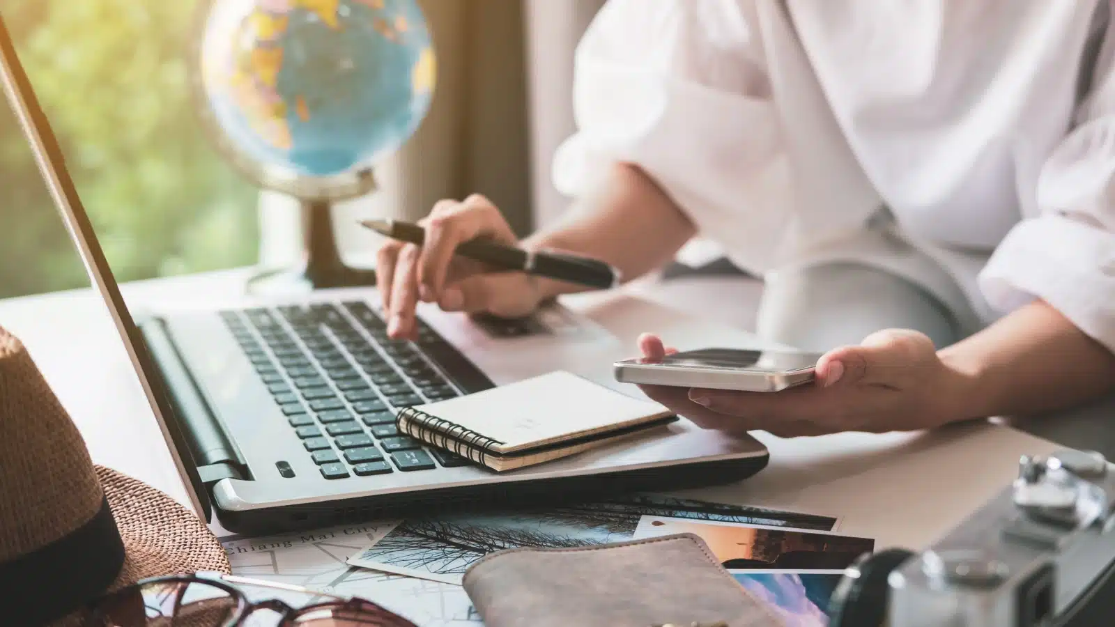 A woman doing travel planning on her laptop to represent how to prepare for a trip.