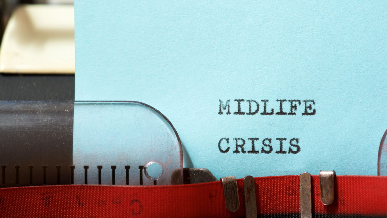 A paper sticking out of a typewriter with the words "midlife crisis" on it to represent the interent's midlife crisis.