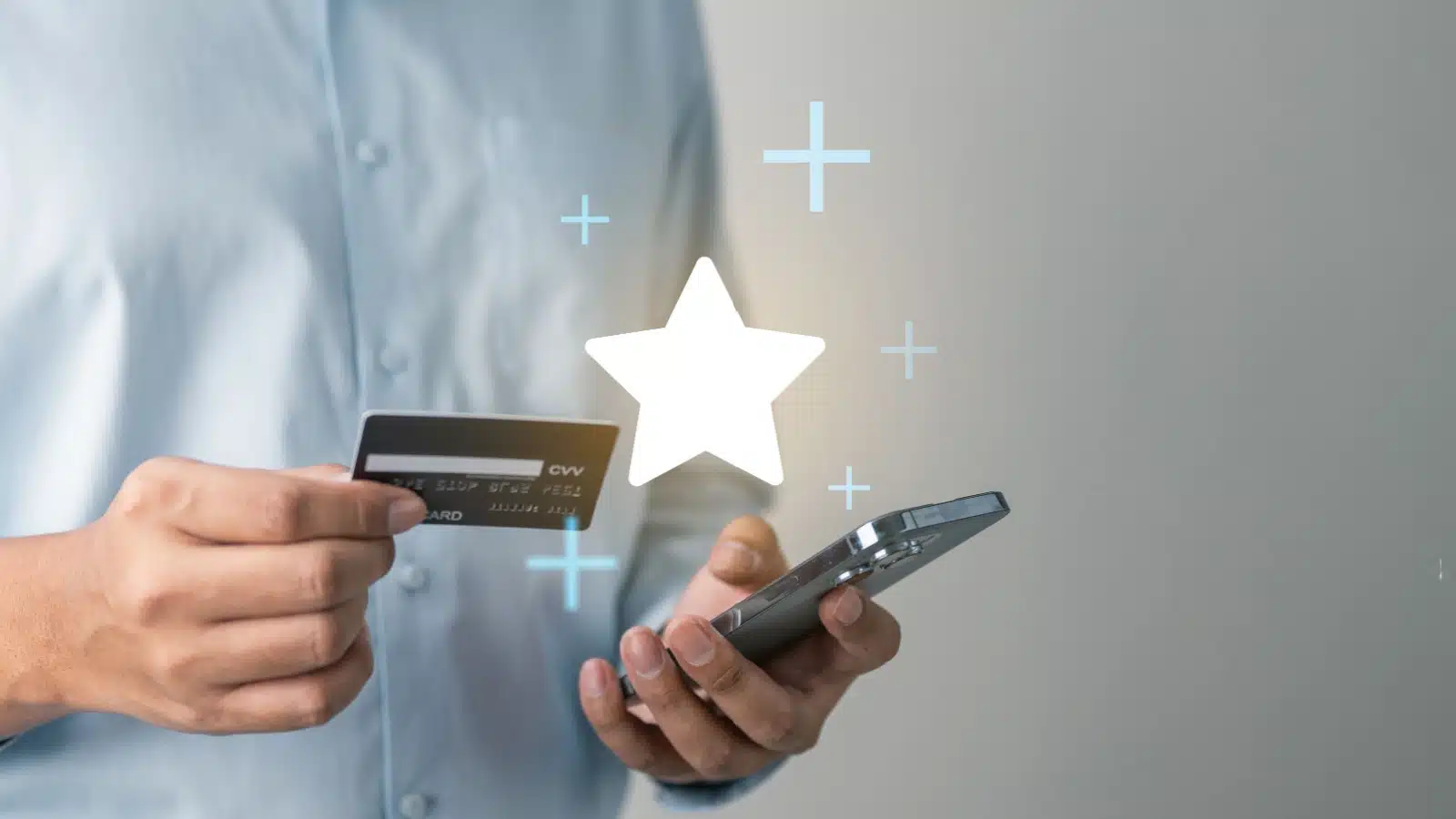 A man using a credit card while shopping online. A big star is shining over the phone, to represent how to leverage credit cards for rewards points.