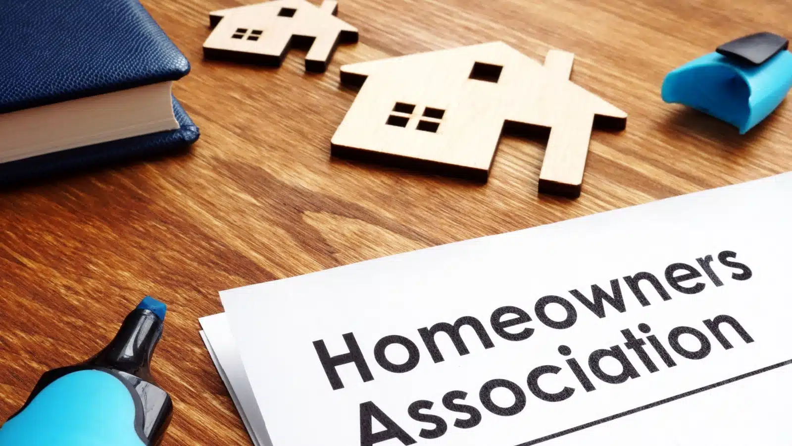 Documents on a table labeled "homeowners association."
