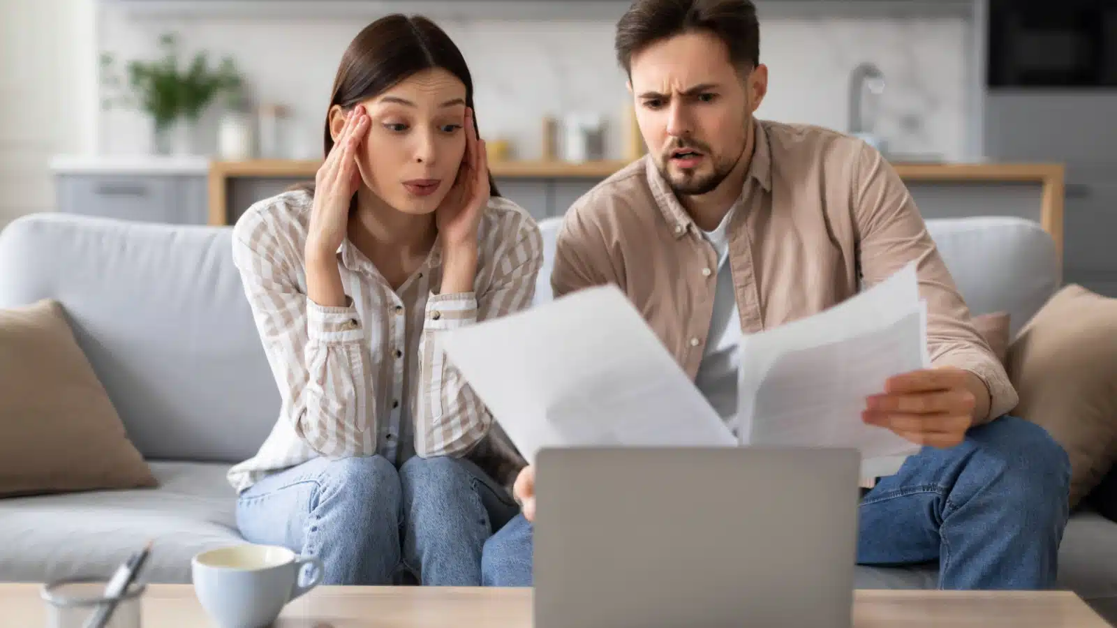 A couple sits together on the couch, trying to understand a confusing investment.