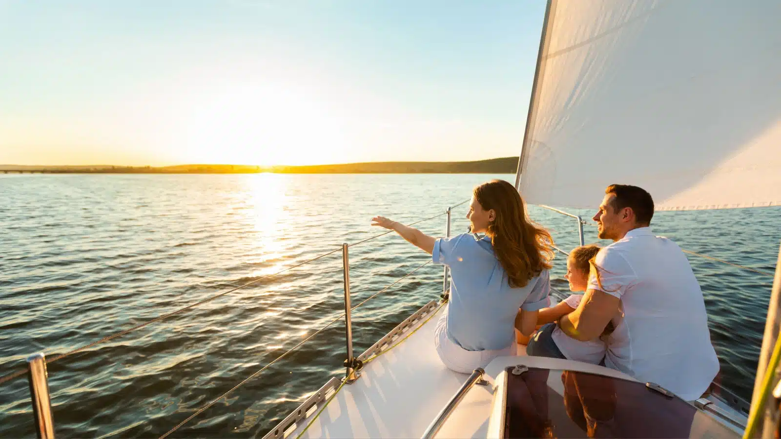 A family enjoying an afternoon in a sailboat.