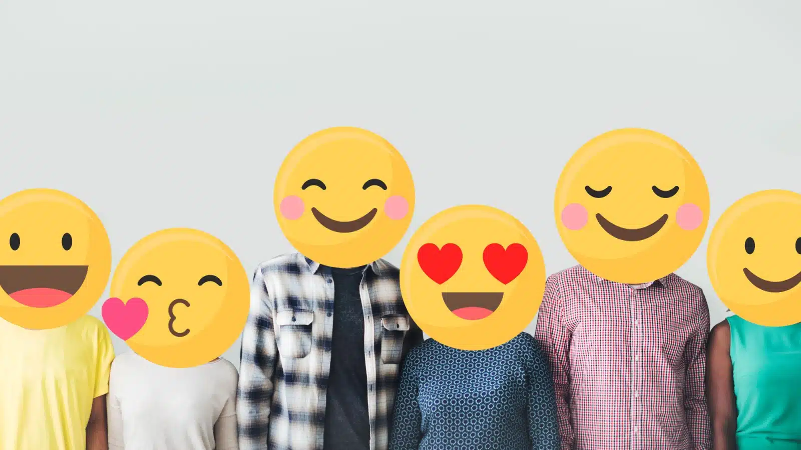 A group of people with their faces replaced by various happy emojis, to represent the question "what is happiness?"