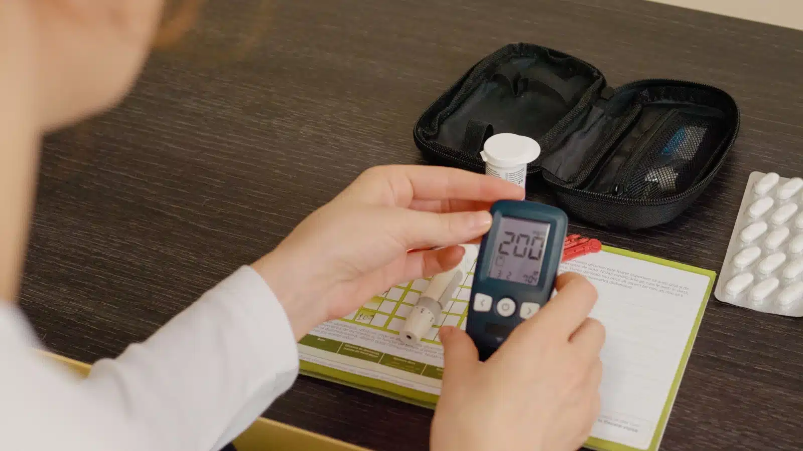 A diabetic woman records her symptoms in a journal.