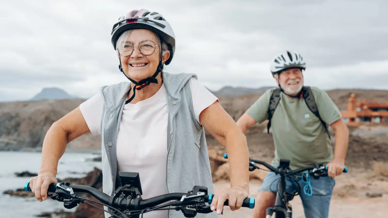 A senior couple enjoys an epic bike ride, to highlight that there are no age limits to life goals.