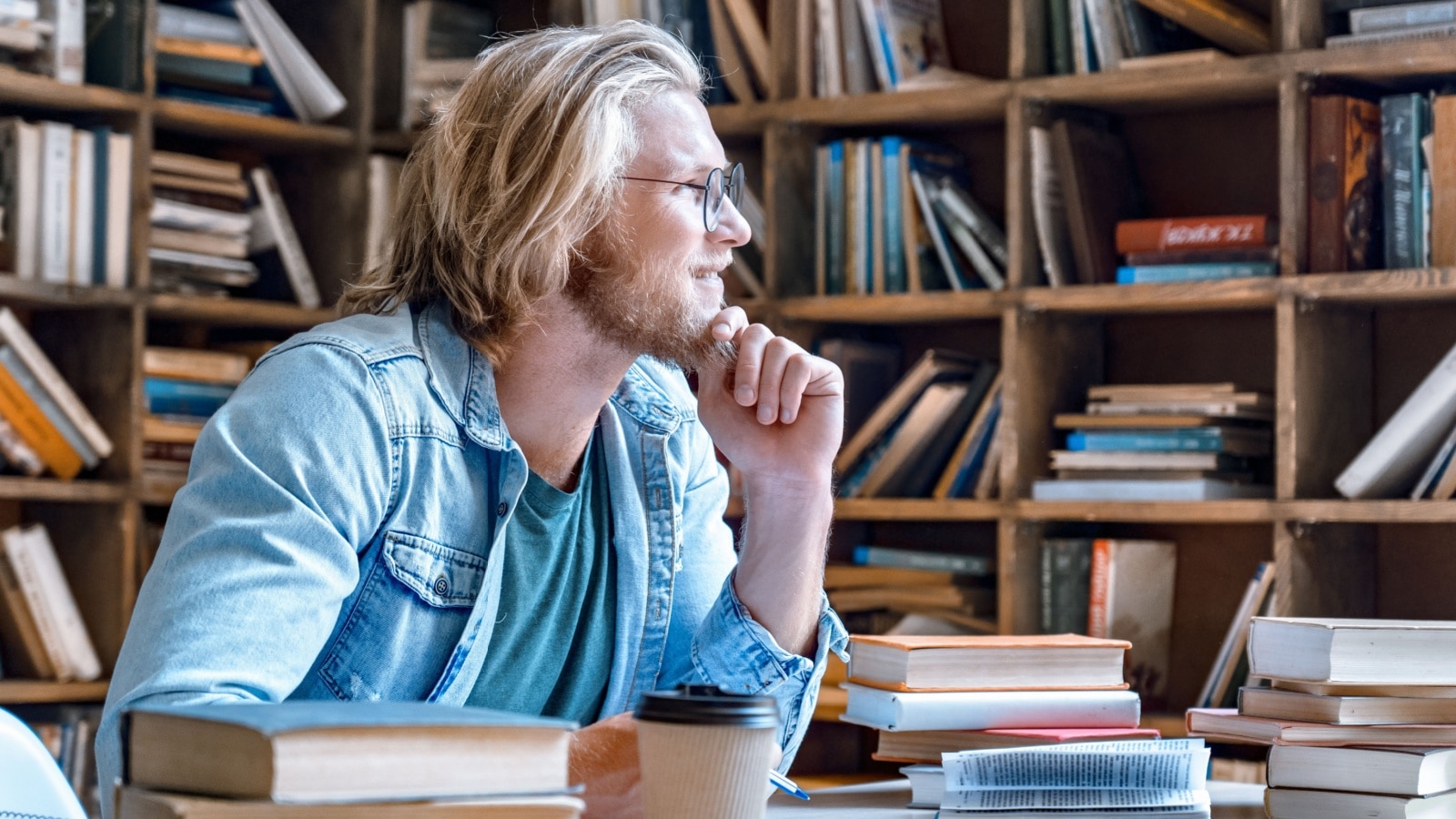 A male author thinking in the library to represent men writing women.
