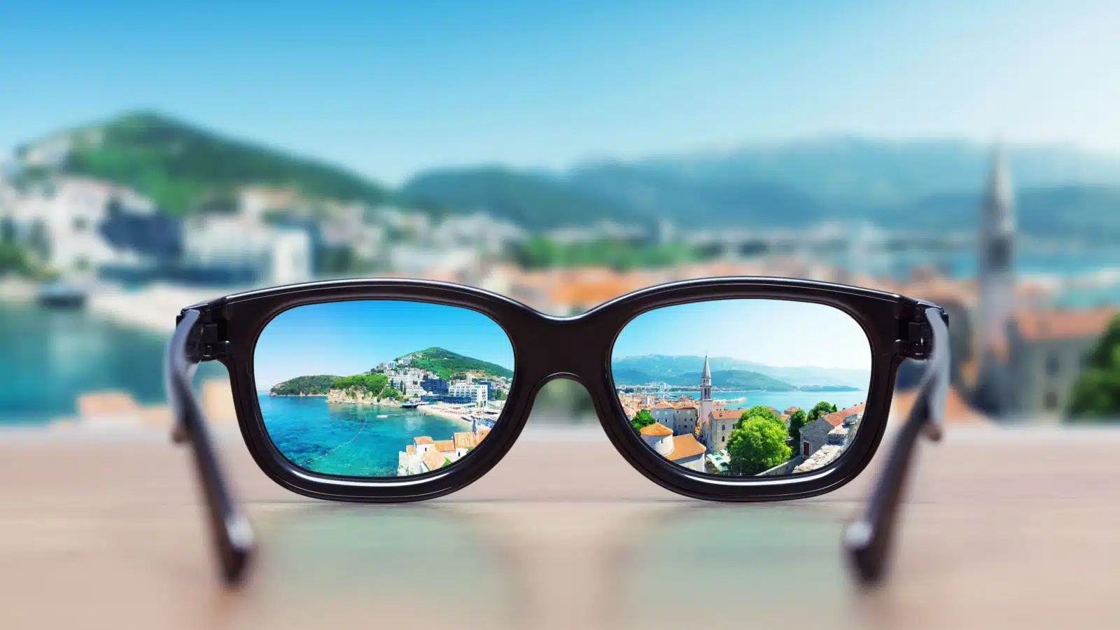Glasses laying on a table put a gorgeous city landscape into focus. Sometimes you have to look at something the right way to see it.
